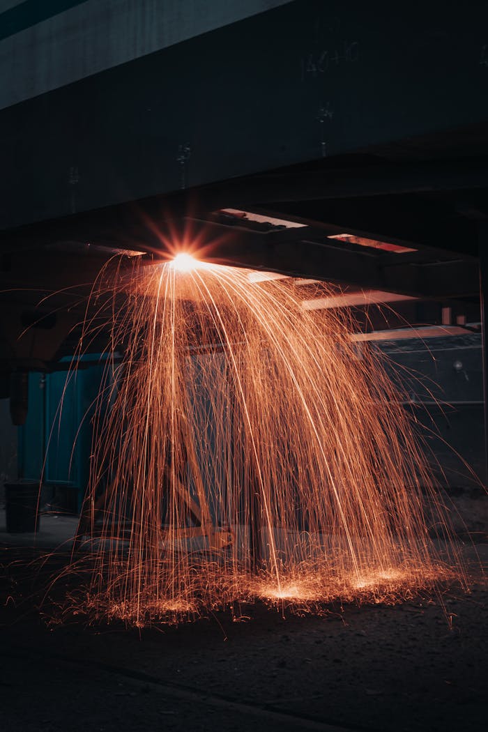 Sparks flying during metal cutting in an industrial workshop.